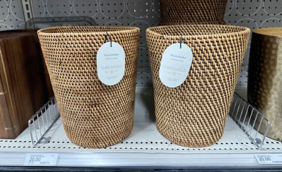 two rattan woven waste baskets on a store shelf