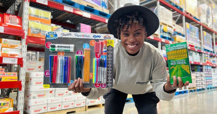 woman holding school supplies in store