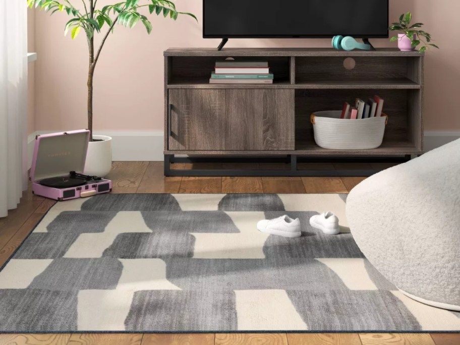 a grey and white modern style rug in a living room