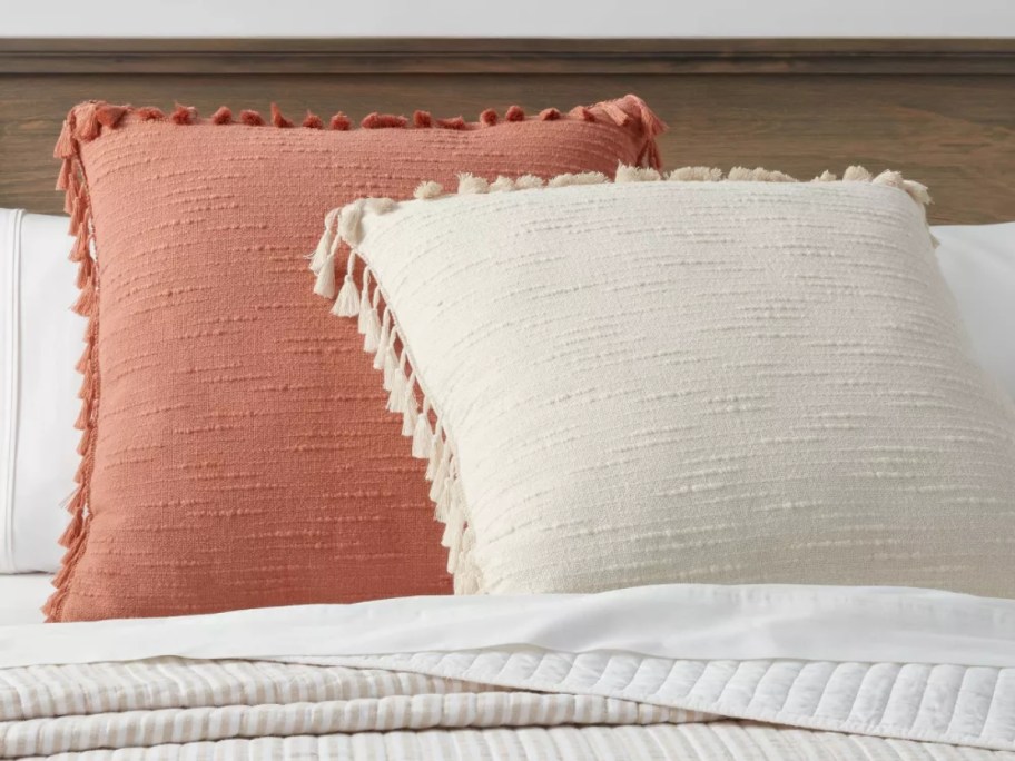 2 throw pillows on white bedding