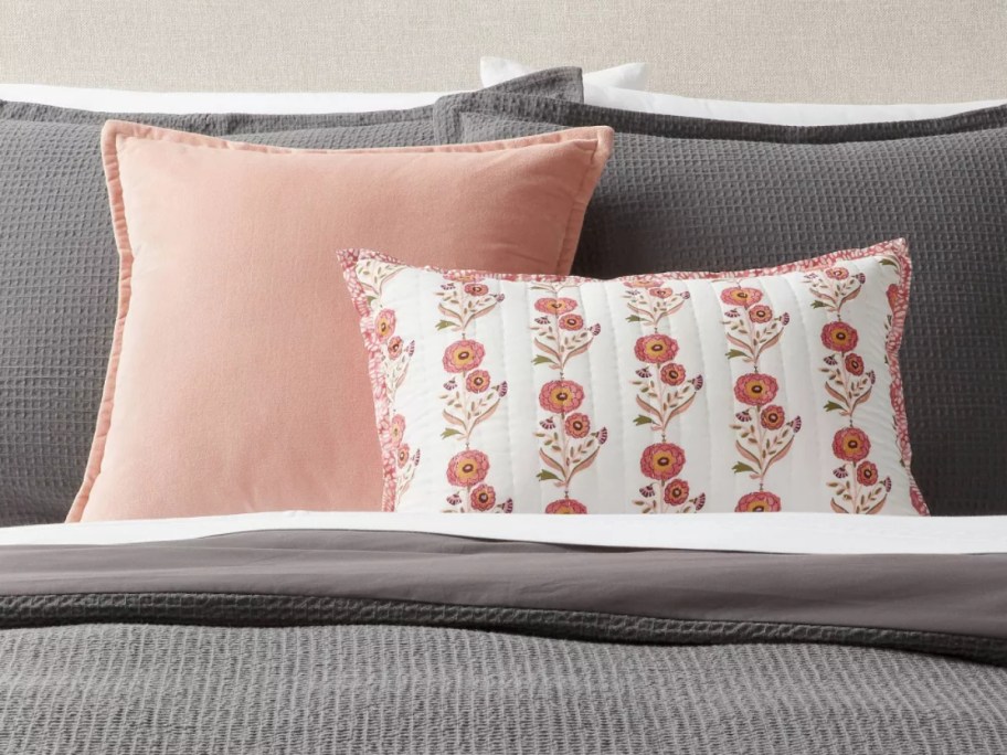 throw pillows on gray bedding