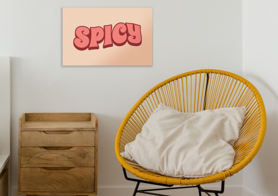 Yellow design chair in bright minimalist bedroom with wooden furniture, wooden floors and white walls