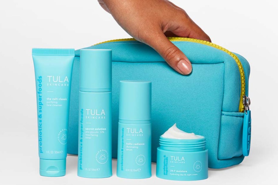 hand grabbing cosmetic pouch next to skincare