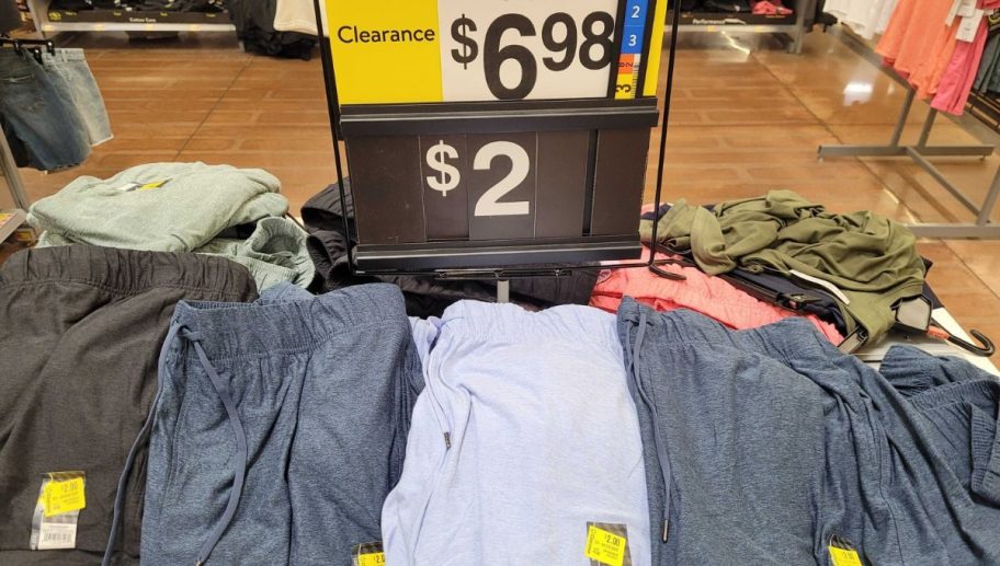 clearance shorts on a display table in a walmart store