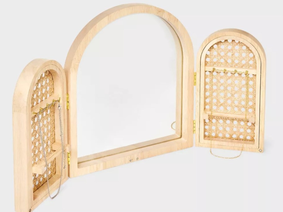 triple arch wood and rattan jewelry organizer with mirror shown open