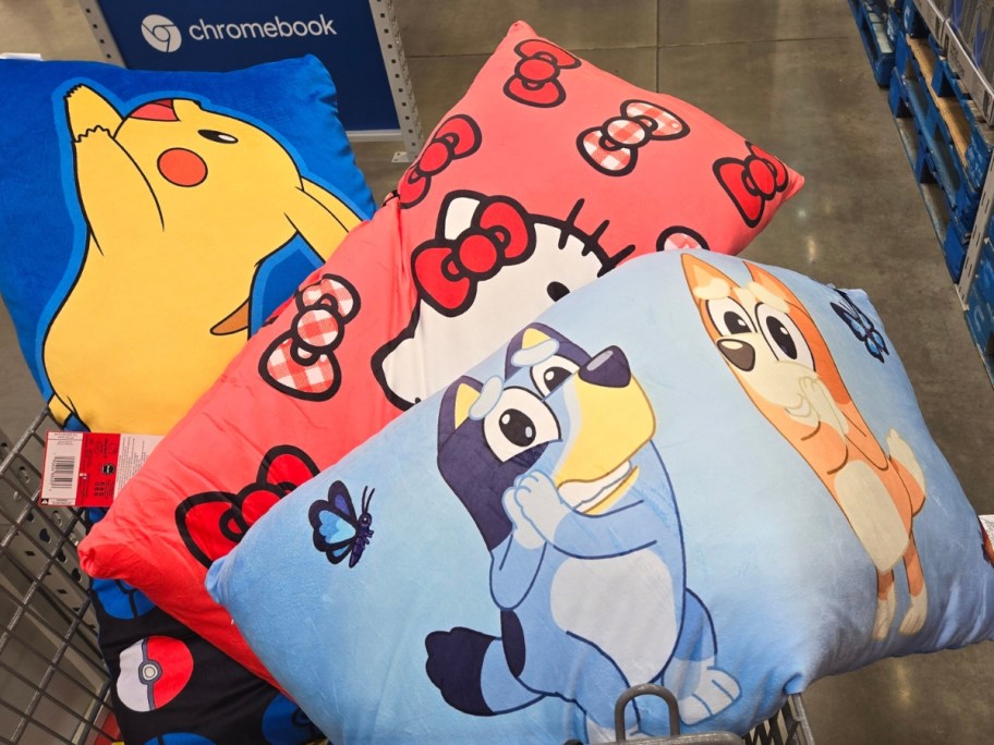 kid's Bluey, Hello Kitty, and Pikachu body pillows in a Sam's Club cart