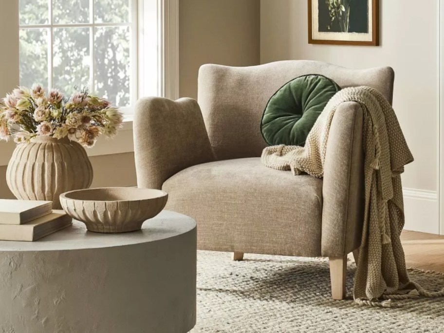 a tan wide wingback accent chair in a living room