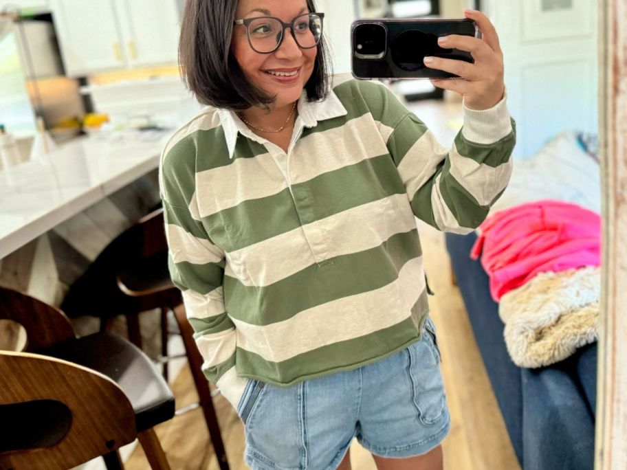 A woman wearing a white and green rugby shirt