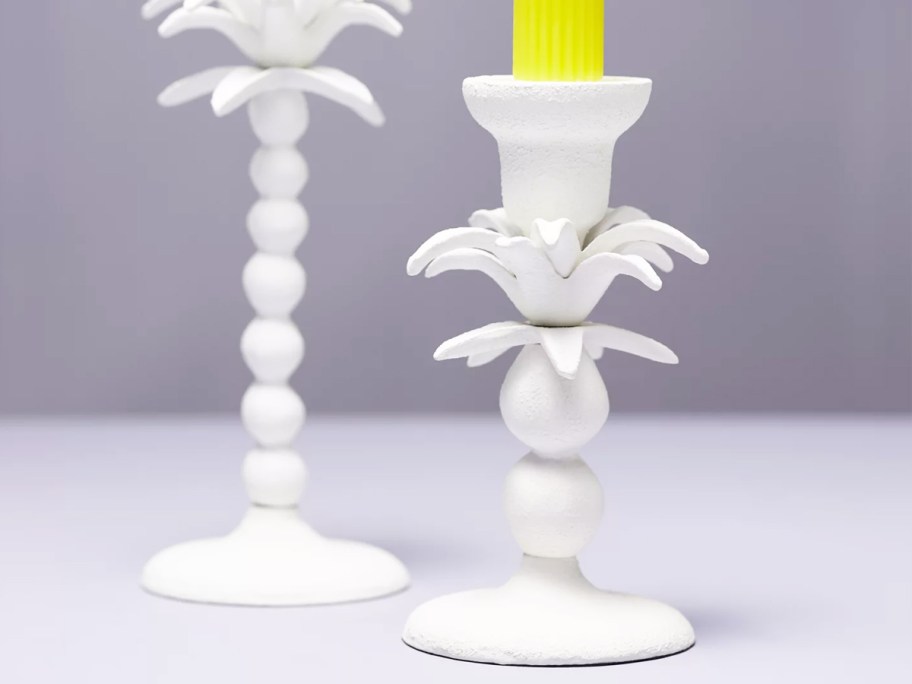 yellow candle in white candle holder