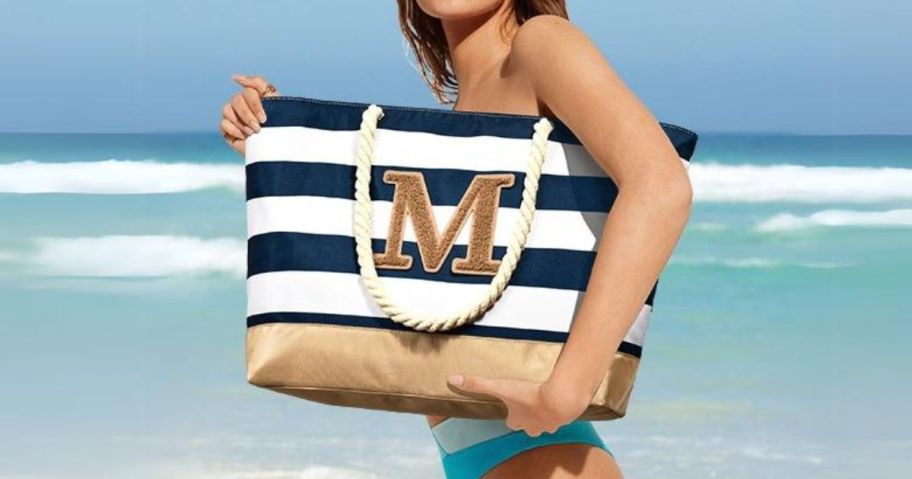 woman holding Becokan Initial Canvas Beach Tote on beach