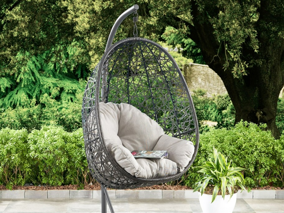 grey hanging patio egg chair on a stand