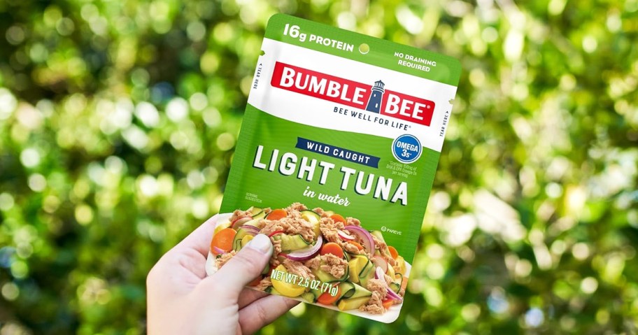 hand holding up a green Bumble Bee Tuna Pouch