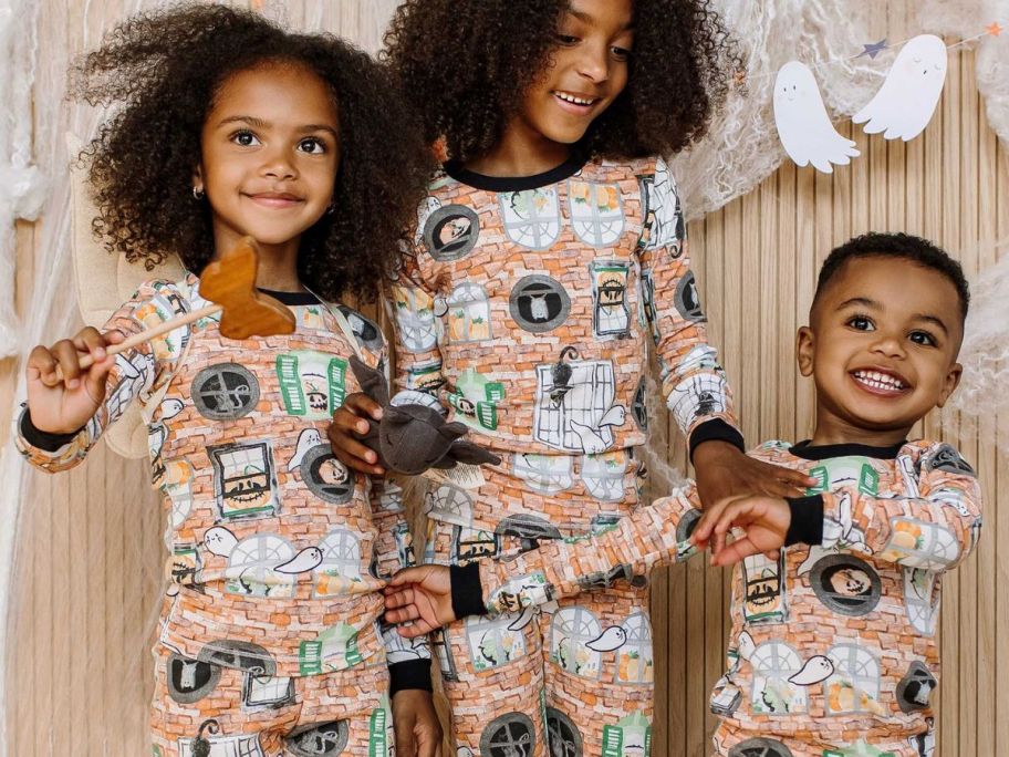 2 kids wearing Burt's Bees Haunted castle Halloween Pajamas