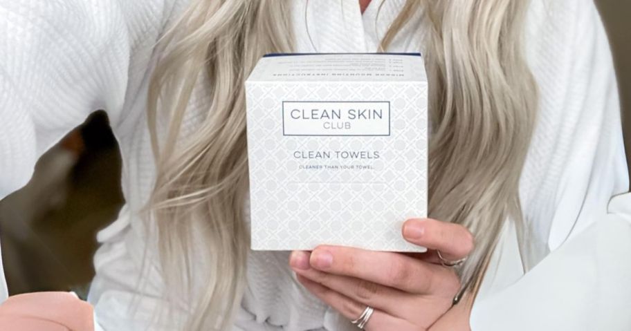 woman holding Clean Skin Club Clean Towels box