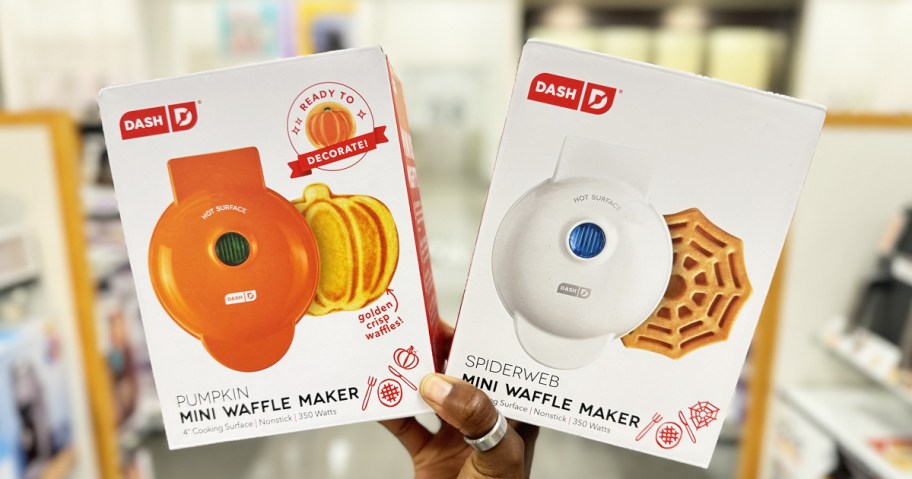 hand holding pumpkin and spiderweb mini waffle makers