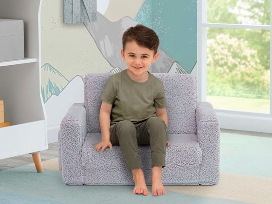 boy sitting on Delta Children Cozee Sherpa 2-in-1 Flip Chair