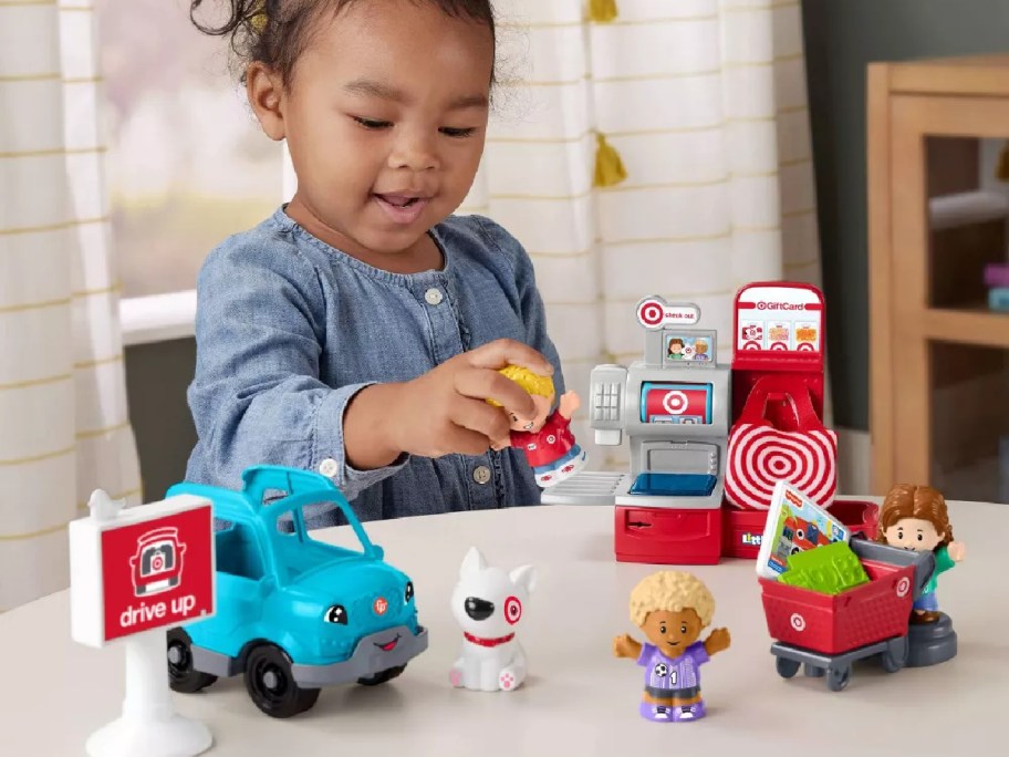 little girls playing with a Fisher-Price Little People Target Run Playset