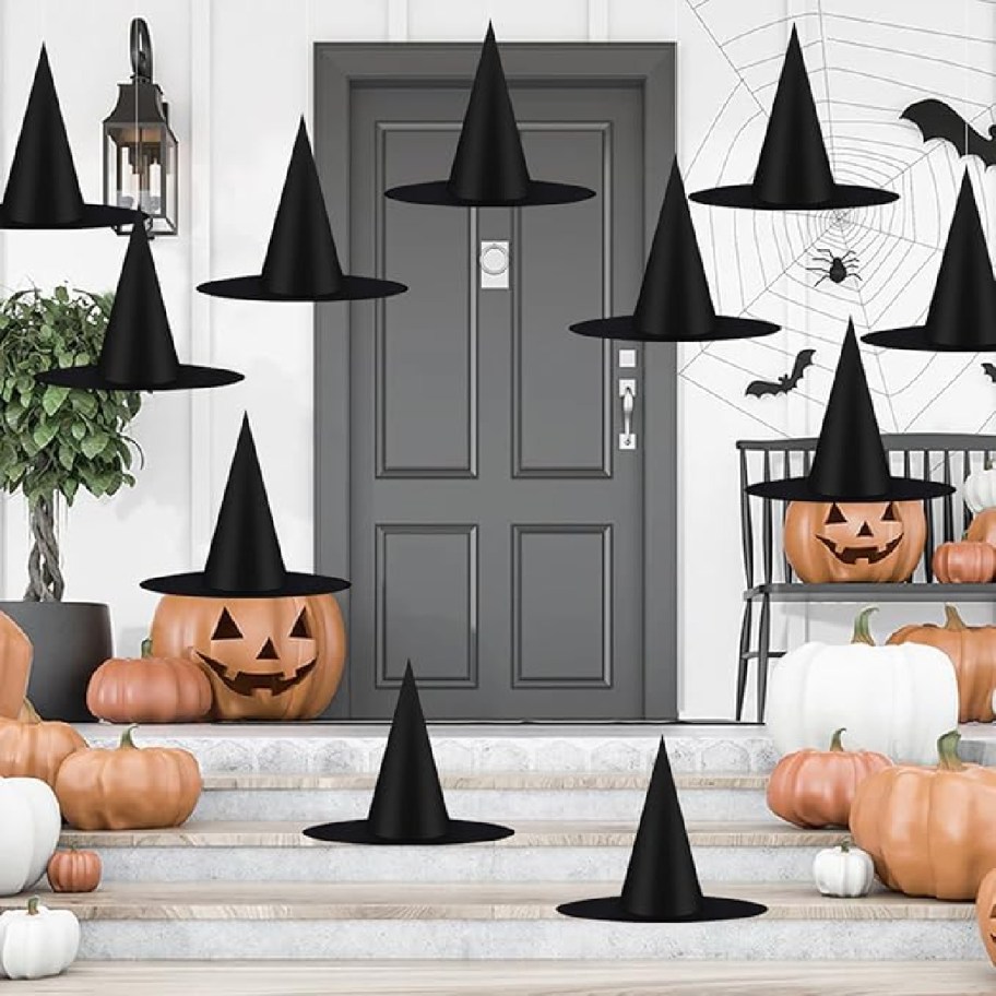 Hanging Witch Hats as Halloween decor on a front porch