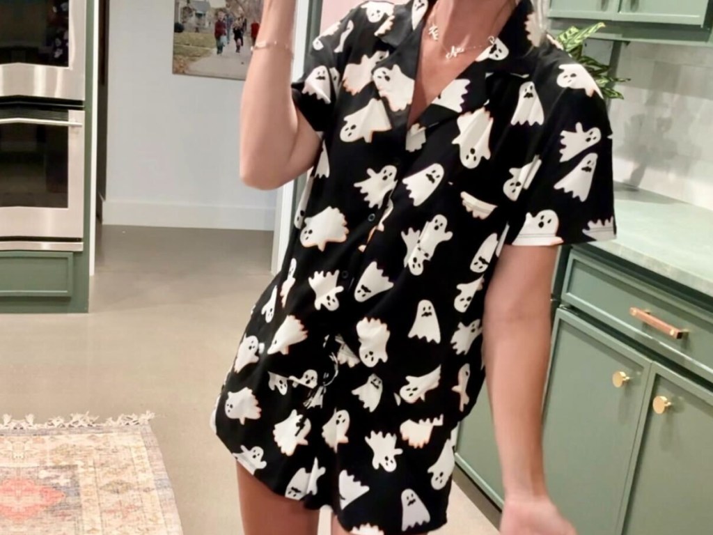 woman wearing black and white ghost pajamas in kitchen