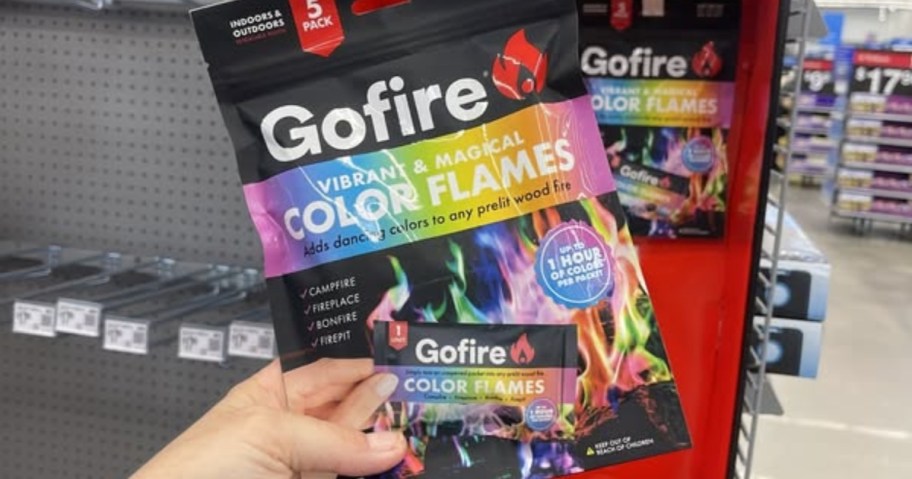 hand holding a pack of GoFire Northern Lights Color Flames in a store