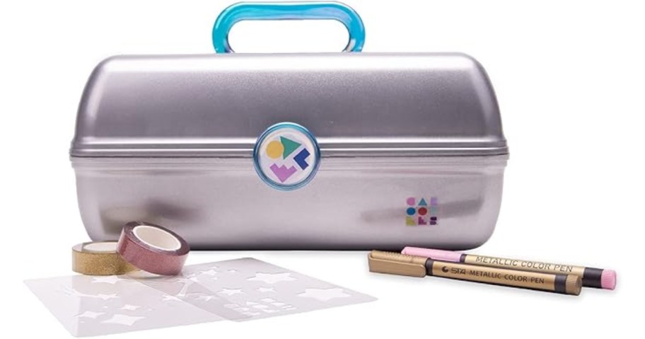 a silver Caboodles makeup case with a blue handle with markers and washi tape rolls in front of it