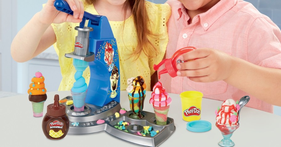 kids playing with a Play-Doh Drizzy Ice Cream Playset making Play-Doh ice cream cones and sundaes