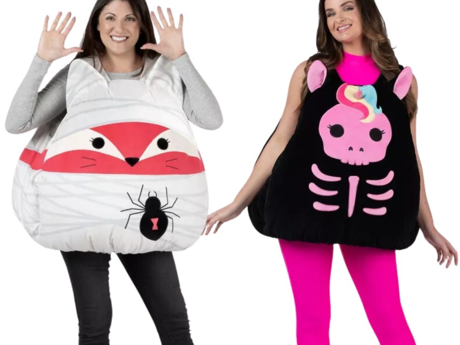 woman wearing a fox as a mummy Squishmallow Halloween costume and woman wearing a skeleton unicorn Squishmallow Halloween costume