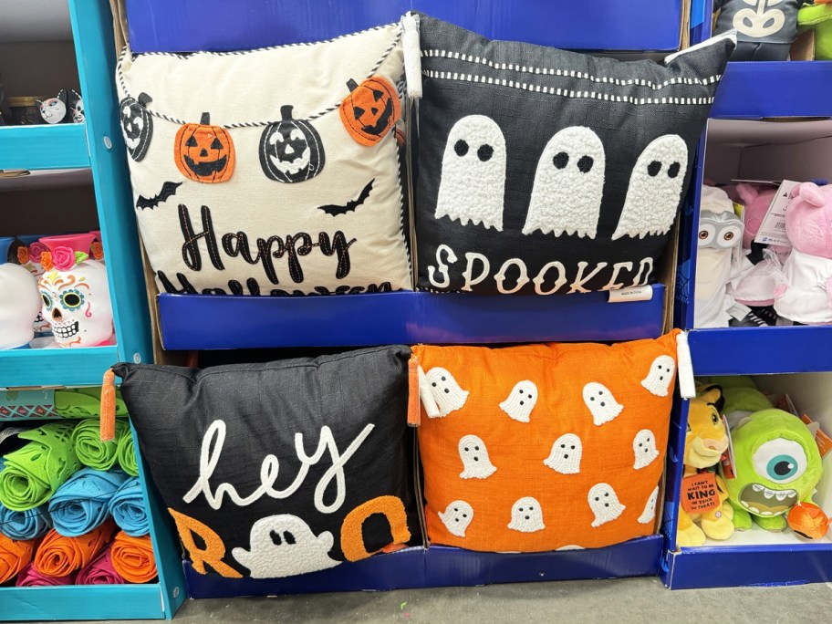 in store display of halloween throw pillows