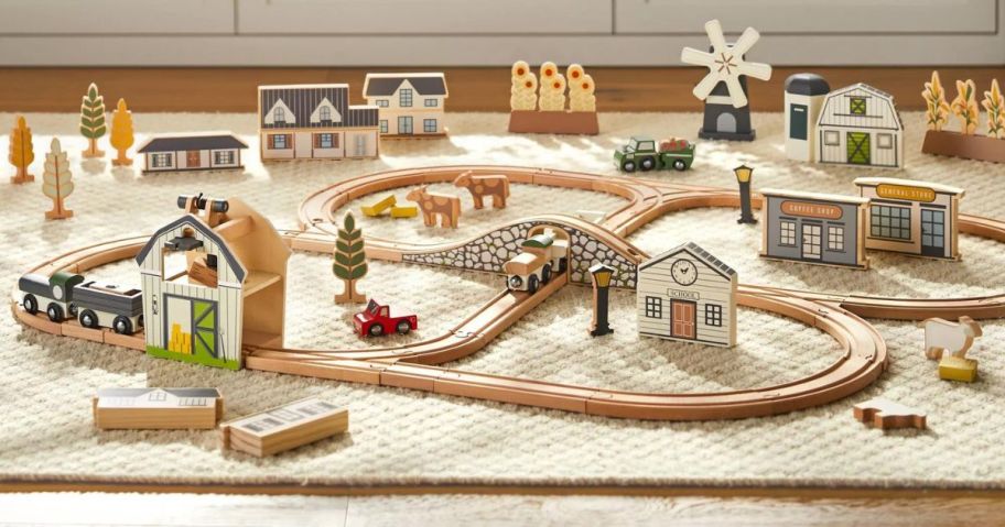 A wooden train set set up in a room