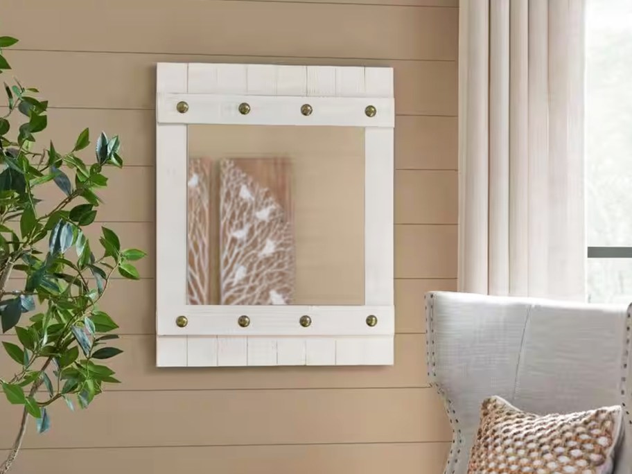 white shiplap wood mirror on wall