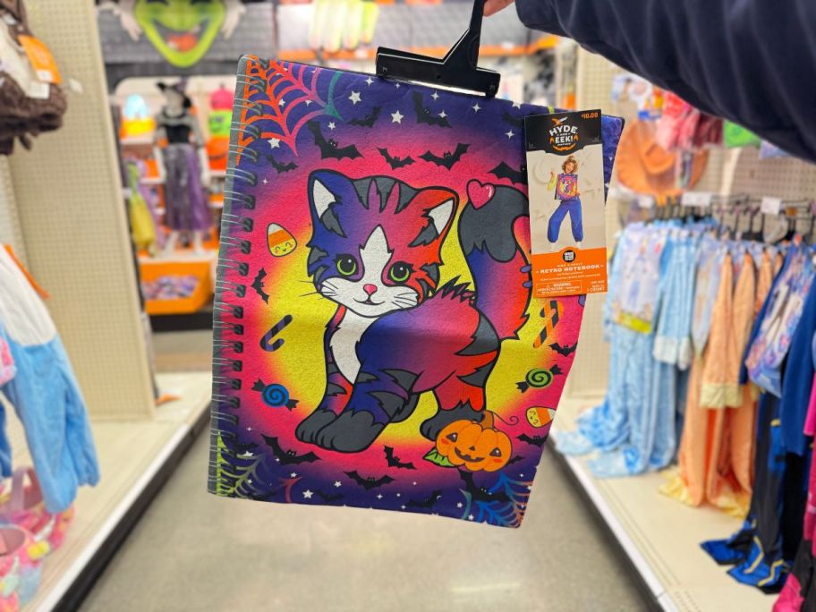 Hyde & EEK! Boutique Kids + Adult Retro Notebook Halloween Costume Sandwich Board in hand in store