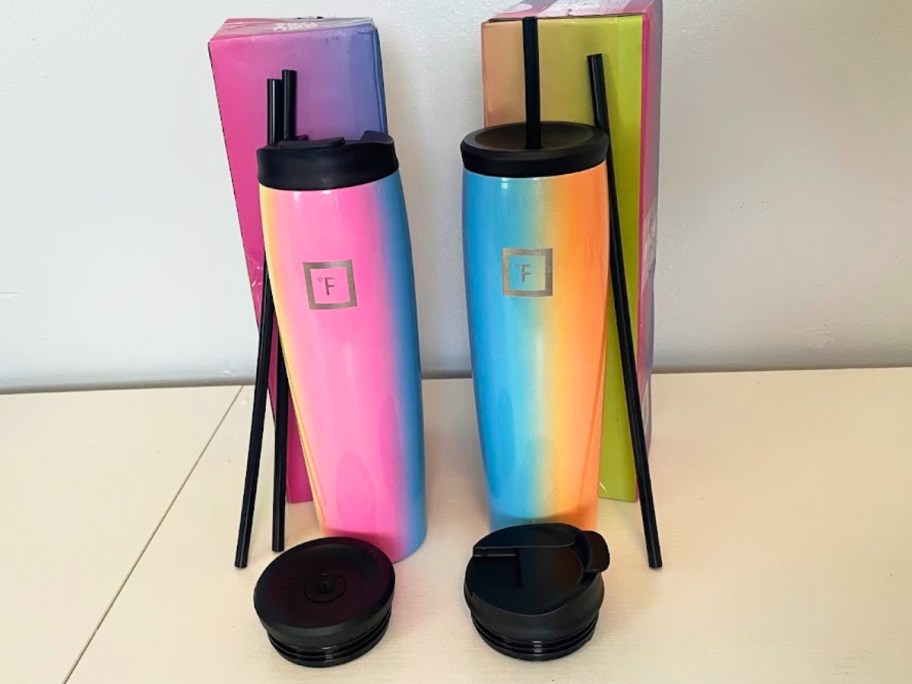 two rainbow tumblers with lids and straws