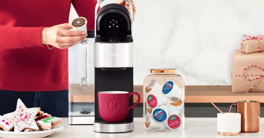 Woman making a cup of coffee with a Keurig Brewer