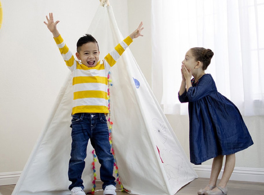 Kids playing with a tent in their room