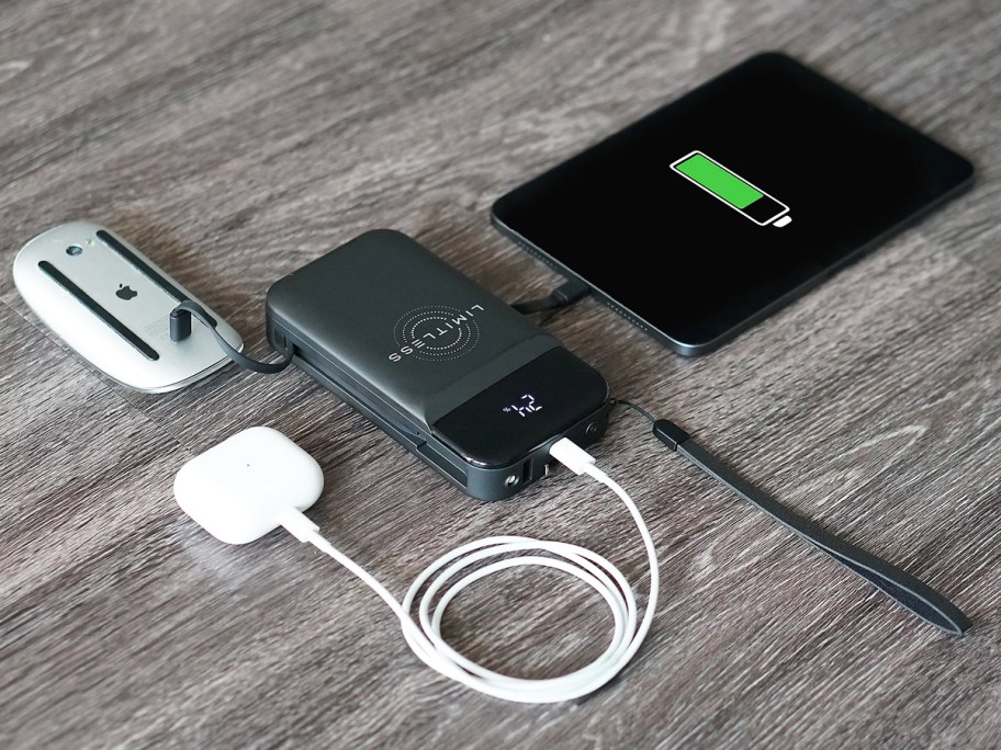 mouse, airpods, and ipad plugged into black power bank