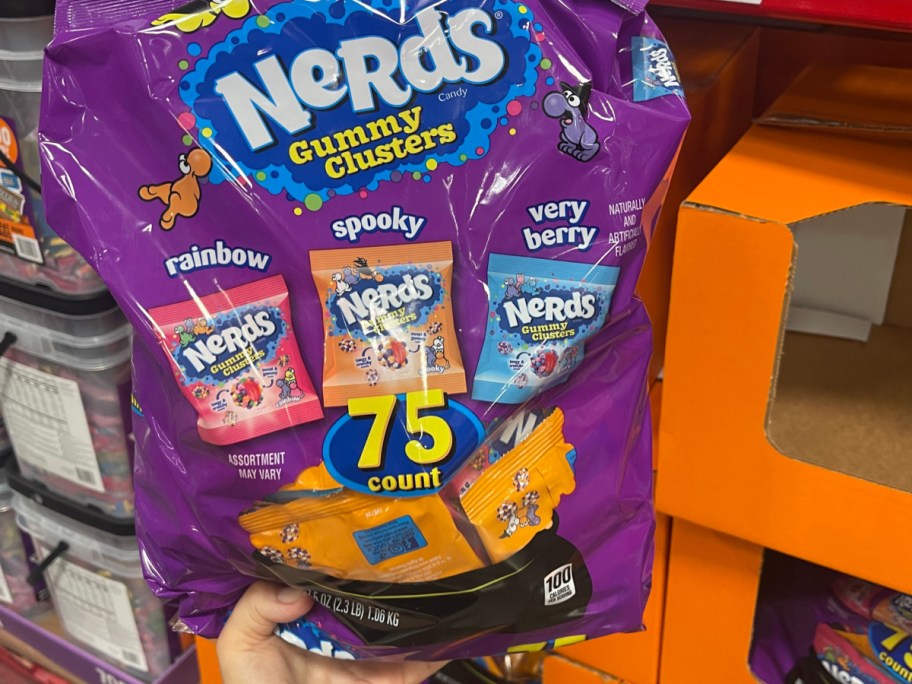 person holding nerds gummy cluster bag in sams club