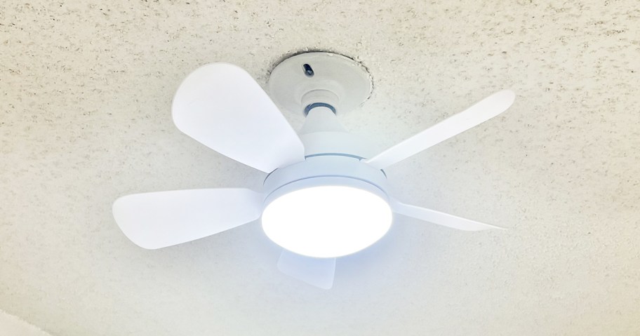 white ceiling fan plugged into light socket