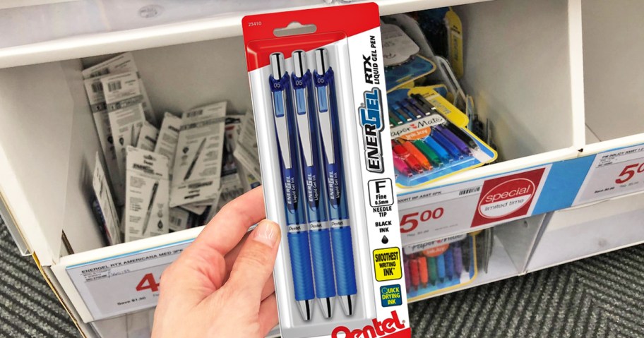 hand holding up a 3-pack of Pentel EnerGel Pens in store