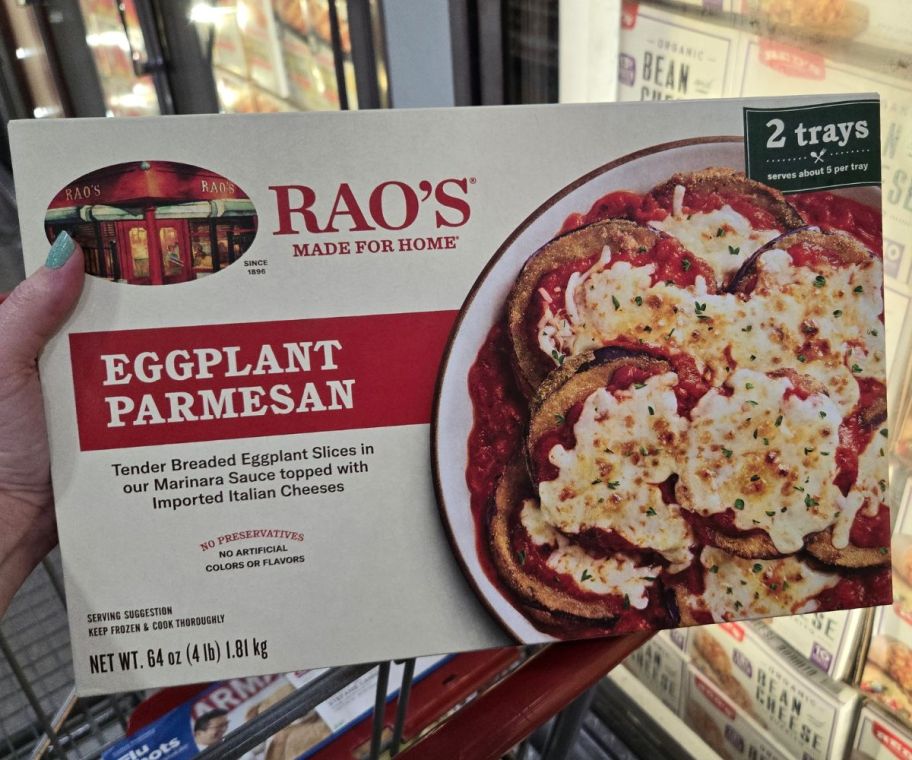 a woman's hand holding a box of frozen eggplant parmesan