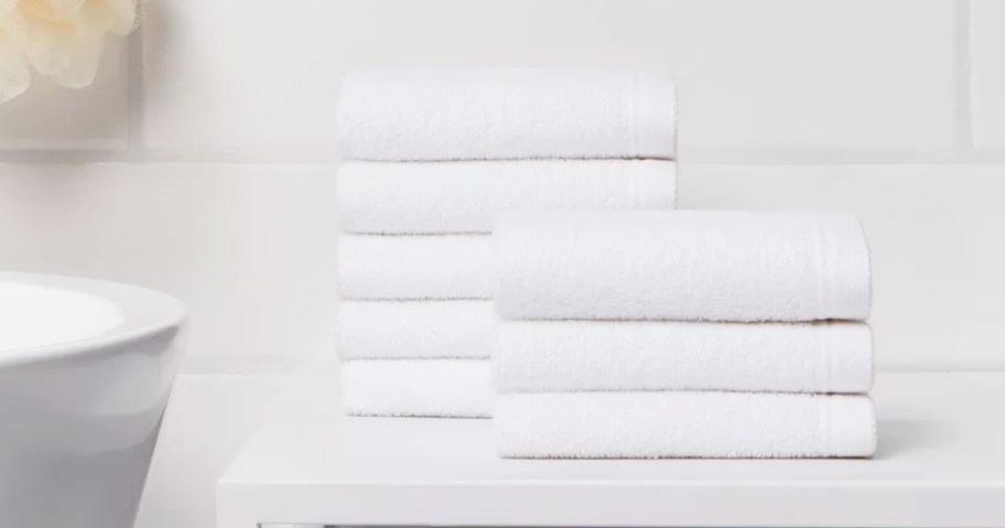 stack of white washcloths on bathroom counter