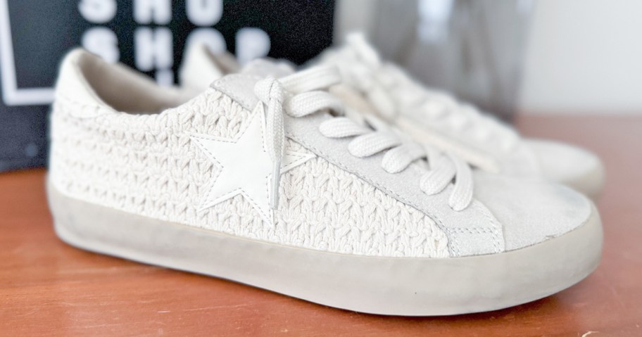 pair of white crochet star sneakers on wood table