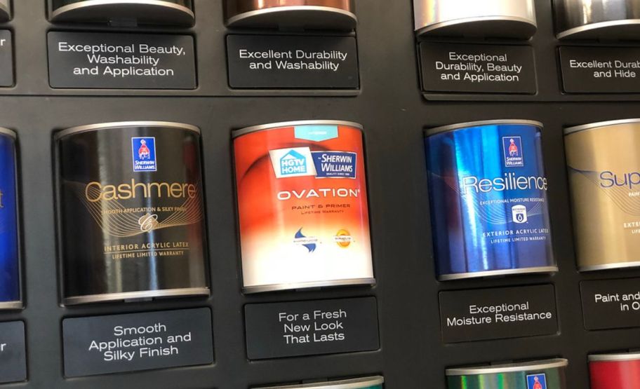 cans of various types of sherwin williams paints displayed on a wall