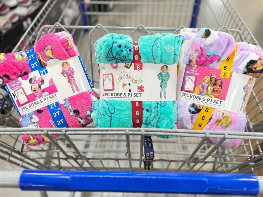 A Sam's shopping cart with 3 Licensed Character pajama and robe sets