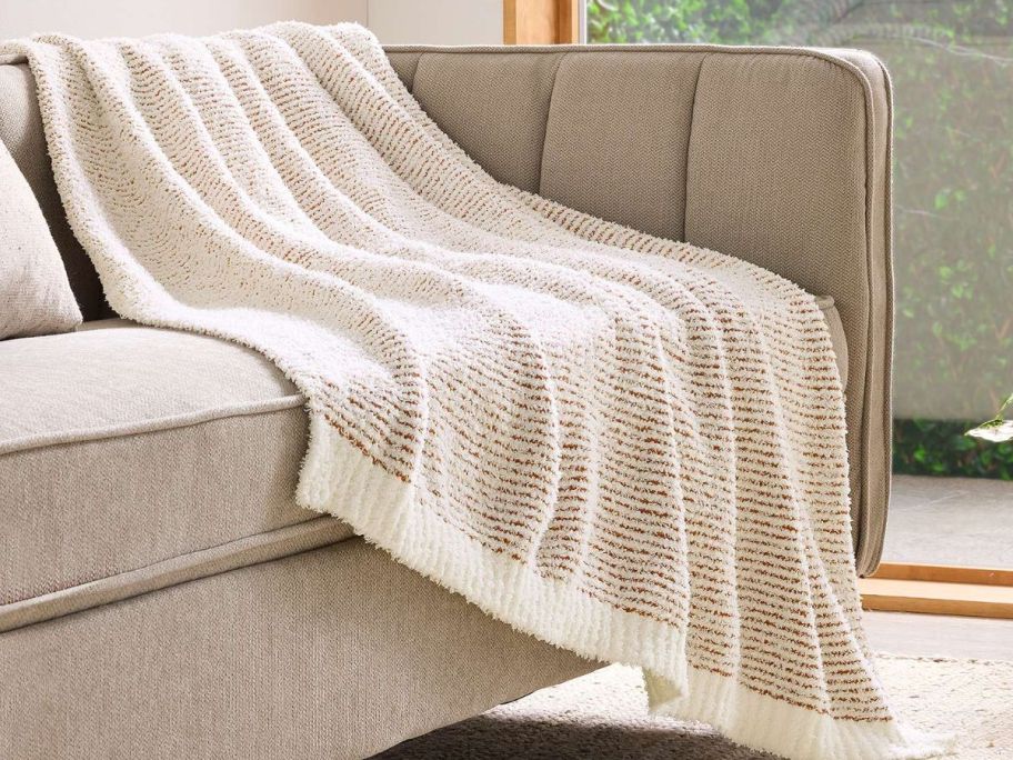 A Sonoma Goods For Life Eyelash Knit Throw Blanket on a couch 