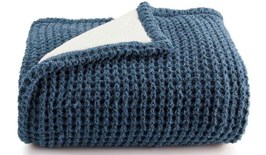 A blue knit throw blanket 