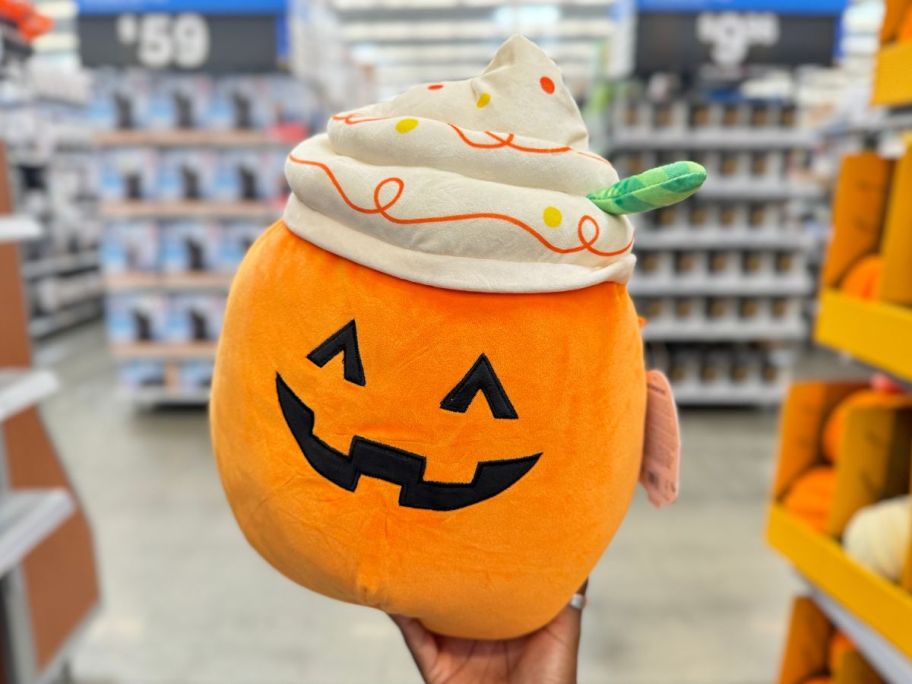 Squishmallows 12" Lester the Pumpkin Latte in hand in store