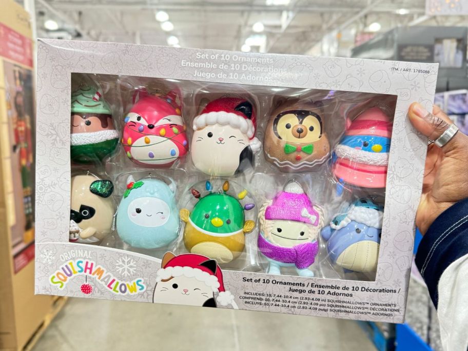 a womans hand holding a 10 pack box of squishmallow ornaments