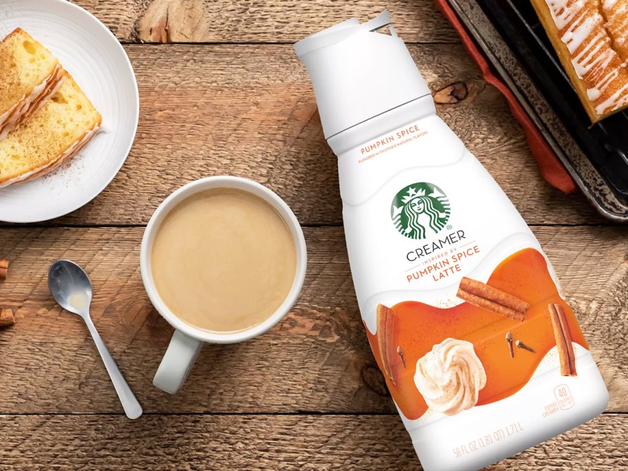 large bottle of Starbucks Pumpkin Spice Latte Creamer near cup of coffee