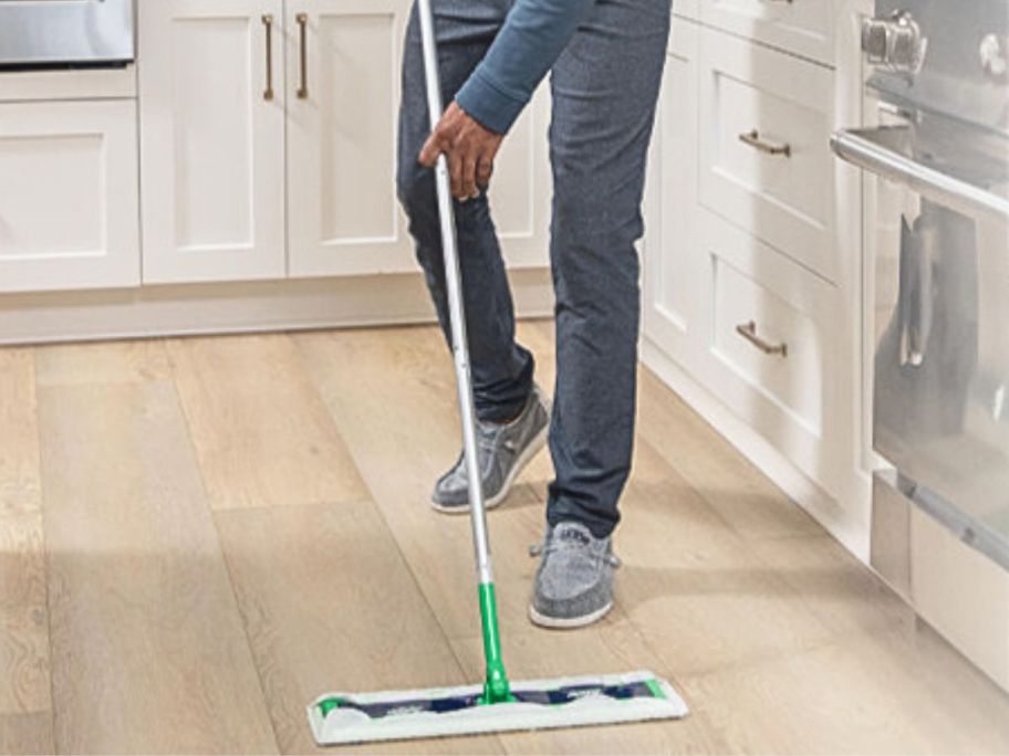 Man using a Swiffer XL to clean a kitchen floor