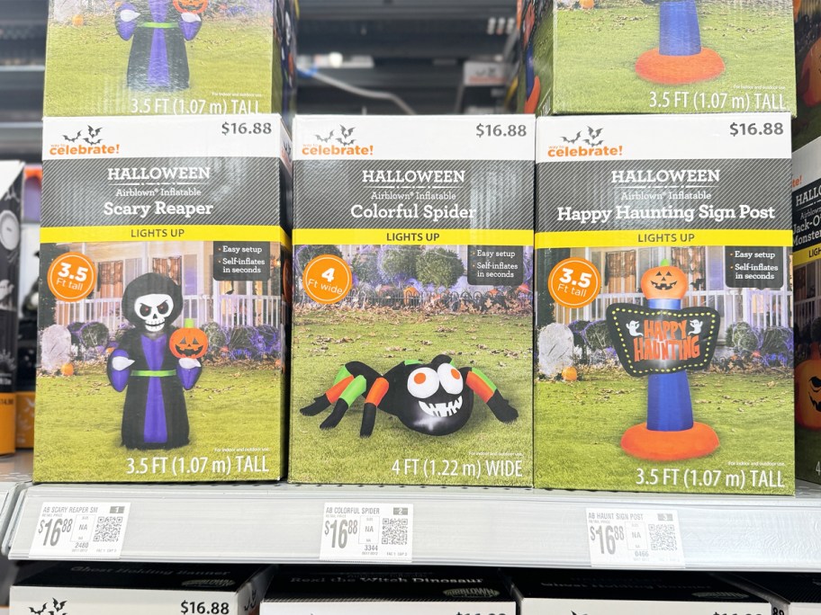 boxes of halloween inflatables on store shelf